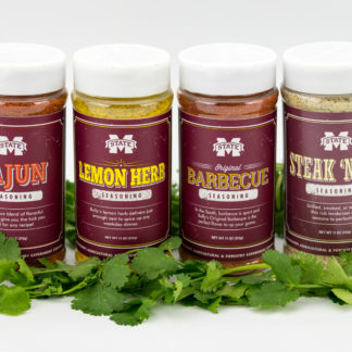 11 oz jars of barbeque, cajun and lemon herb seasonsing and 14.5 oz jar of steak and rib seasoning surrounded by cilantro