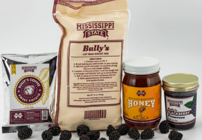 1.75 oz sweet potato coffee, 16 oz bag of cat head biscuit mix, 22 oz of wildflower honey, 9 oz jar of blackberry preserves with blackberries in the foreground