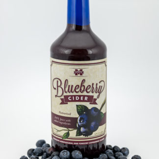 32oz bottle of blueberry cider surrounded by blueberries